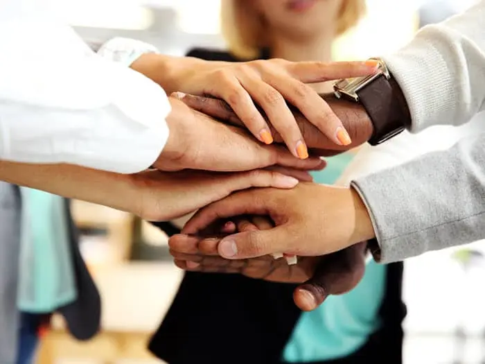 trusted community expressed by overlaying of multiracial hands